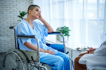 Obraz premium Hospital wheelchair patient doctor wellness therpy rehabilitation consultation healthcare recovery during medical visit by window, pensive adult in gown seated, soft light brings hope and therapy