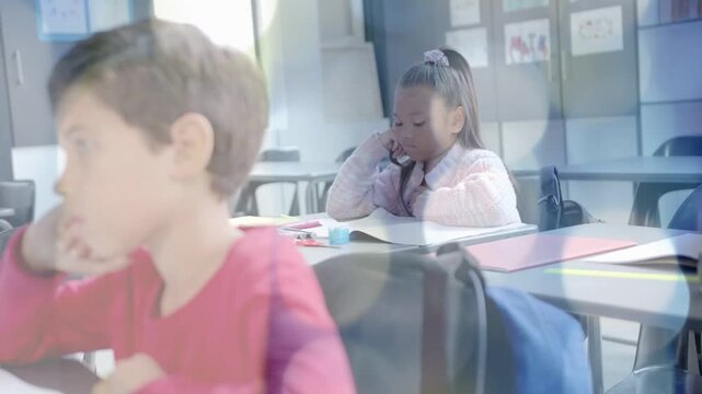 Girl opening workbook, studying in classroom while soft highlights shifting focus for learning