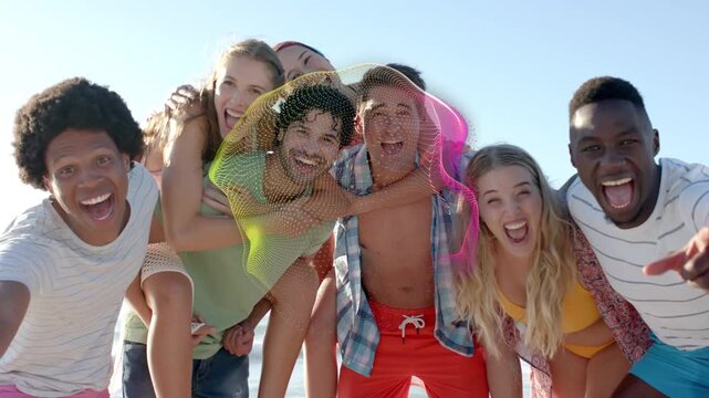 Friends on beach on cue leaning, laughing, digital ribbons sweeping across group for marketing