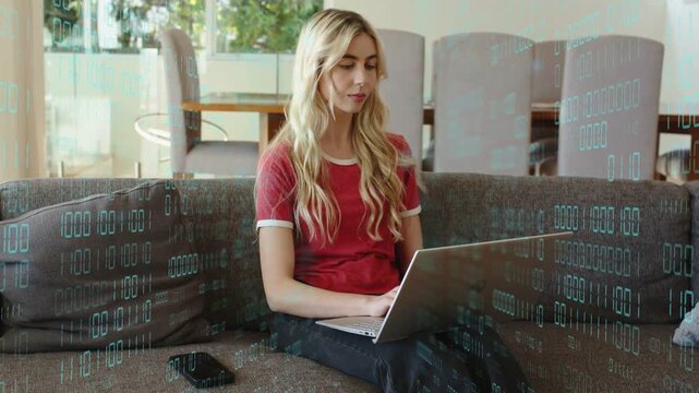 Adult woman on sofa starting typing on laptop, binary digits flowing across device, analyzing data