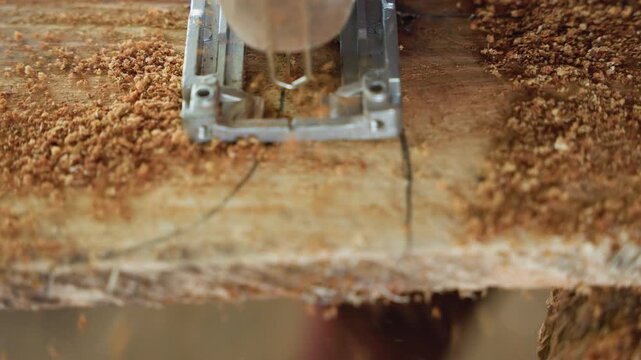 Closeup jigsaw following marked line, carpentry workflow in busy workshop, steady downward cut producing dense sawdust, measured layout lines on board, repetitive precise motion for joinery and fit