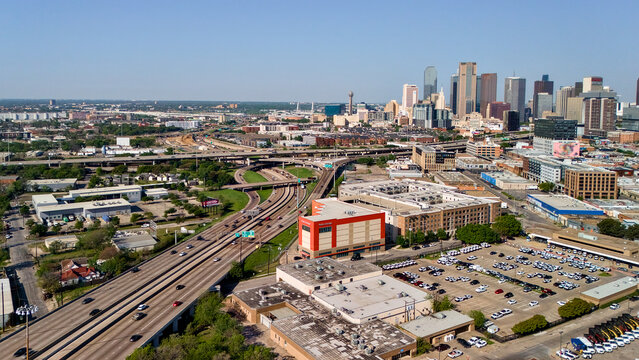 Aerial view of Dallas cityscape with freeway and downtown skyline