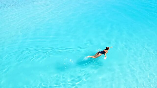 Person swimming in clear blue water