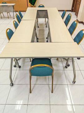 Neatly arranged tables and chairs prepared for group discussion or team meeting in a classroom setting, creating a clean, organized, and professional environment ready for collaboration