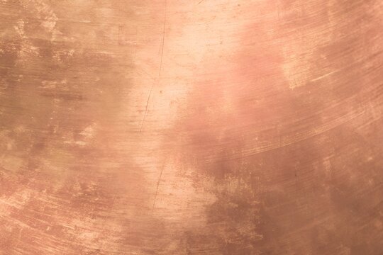 Rose copper metal textured background with weathered circular scratch surface