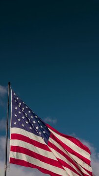 Slow Motion Vertical Seamless Loop of American Flag Waving with Copy Space