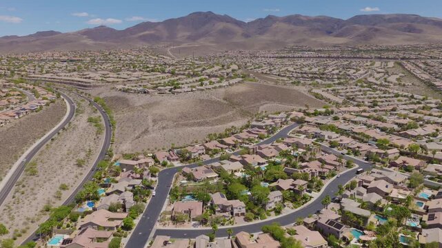 Aerial Wide Pullback Shot of Henderson Suburban Homes Near Desert Mountains