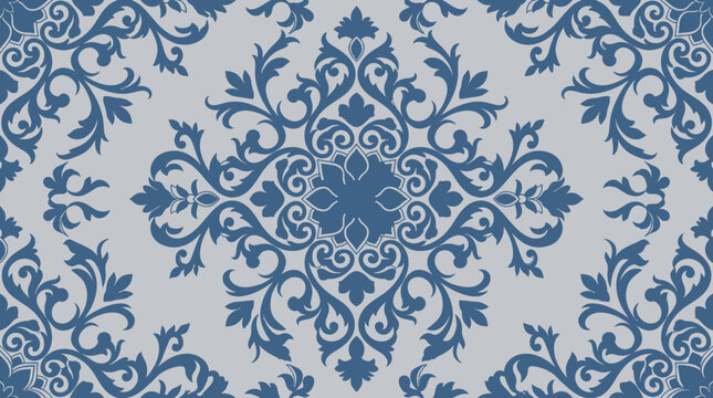 Intricate blue damask pattern with symmetrical floral motifs on a light background.
