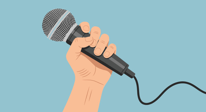 Human hand holding a black wired microphone used for vocal performances and presentations