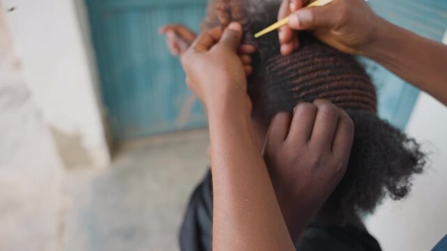 Expert handiwork in hair styling. Meticulous braiding shows patience and craftsmanship. Artful arrangement of curls and braids highlights delicate craftsmanship and careful patience