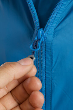 close - up of a zipper of a man 's hand