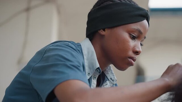Young woman focused on carpentry, closeup workshop scene showing concentrated expression, steady hands working on wood surface, soft natural light, detailed grain and texture, cinematic shallow depth