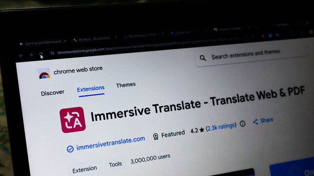 Closeup of a laptop screen displaying the chrome web store page for the immersive translate browser extension