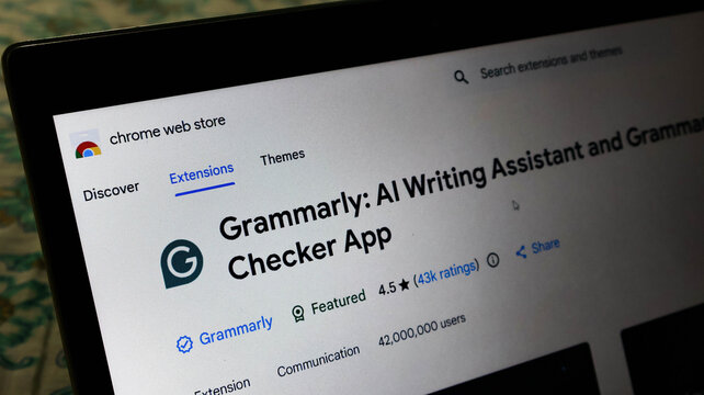 Closeup of the grammarly ai writing assistant and grammar checker browser extension page on the chrome web store on a laptop screen
