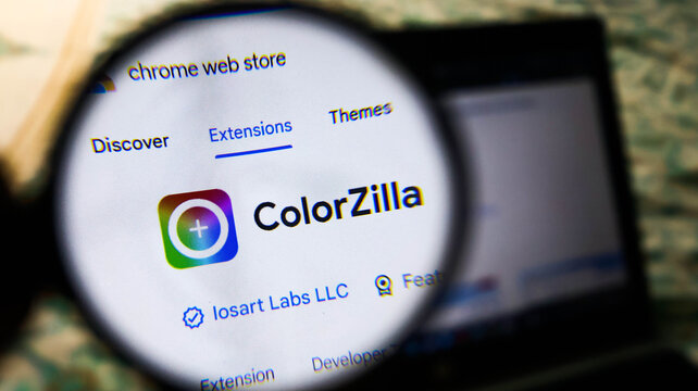 Magnifying glass focused on colorzilla extension in chrome web store on a laptop screen, highlighting the logo and developer details