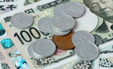 Japanese yen money bills and coins on table. Japan cash of JPY currency close up © Larysa