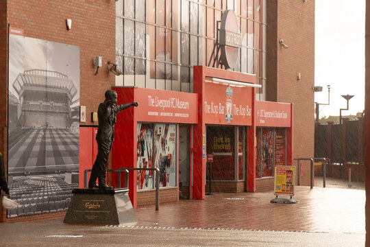 the historic Kop Stand at Anfield Stadium, featuring the bronze statue of legendary manager Bill Shankly. 
