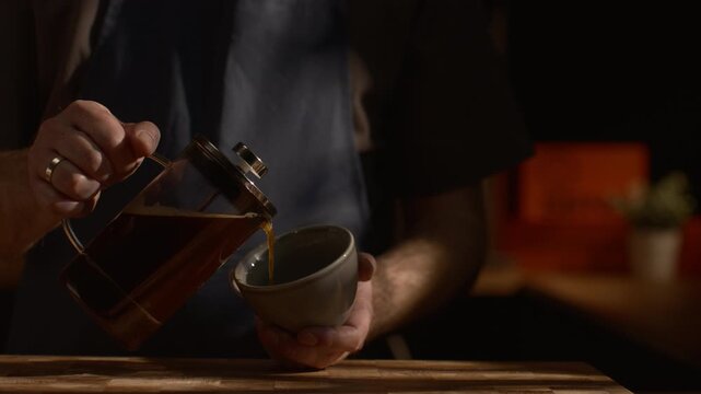 Fresh coffee being poured into cup, smooth liquid flow, steam rising, cinematic slow motion, cozy specialty coffee mood.