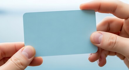 Obraz premium Hands Holding Blank Light Blue Card Mockup