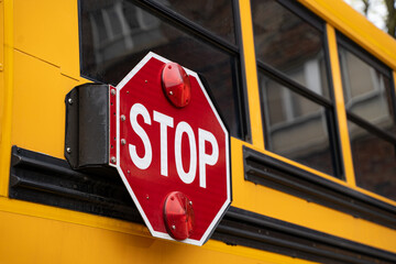 Close up of school bus stop sign with flashing red lights. © Erman Gunes