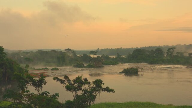 Early morning sunrise at Murchison Falls Uganda as soft light reveals fast flowing Nile River water creating a dramatic and peaceful natural landscape in Africa