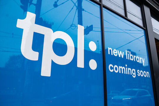 View of TPL new library coming soon sign on building window. Toronto, Canada - April 29, 2026.