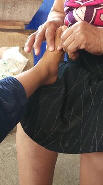 Adult Woman Giving Foot Massage to Child