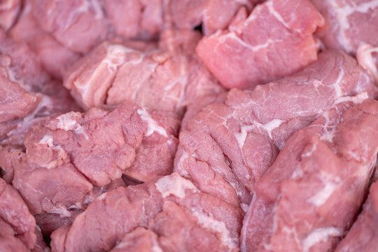 Artisanal meat display. Handcut meat with marbling. Premium natural grain artisanal meat presentation. Closeup of handcrafted meat showcasing marbling and natural texture