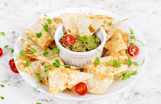 Light snack with avocado dip and crispy chips minimal composition
