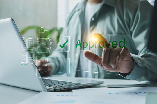 Business professional approving digital document on laptop with green checkmark interface, online workflow verification, success approval process for corporate task management and compliance system