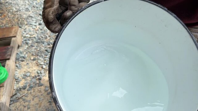 Pouring borax mixture into sprayer.