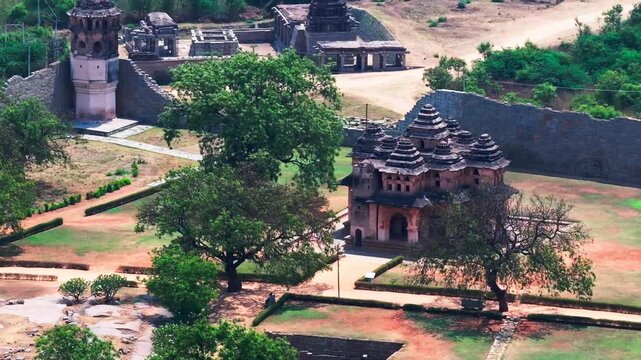 Lotus Mahal with watch tower, trees and Shri Ranganatha Swami Temple at hampi, Karnataka, india. day time, crane shot, drone shot, 4k.