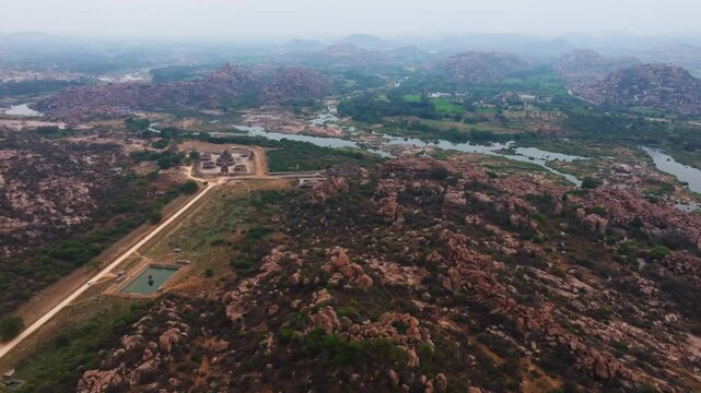 Vitthala Temple with The Stone Chariot, Vittalaraya Kola and mountains at nimbapura, hampi, karnataka, india. day time, zib shot, drone shot, 4k.
