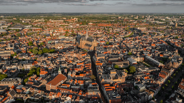 Aerial view of the St. Bavo Church surrounded by historic red-roofed buildings and the urban landscape of Haarlem, Noord-Holland, Netherlands.