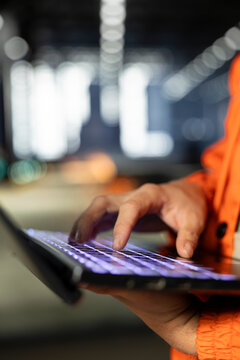 Close up of industry plant staff uses tools and laptop to inspect steel components, illustrating professional labor, engineering concepts and automated development behind industrial production.
