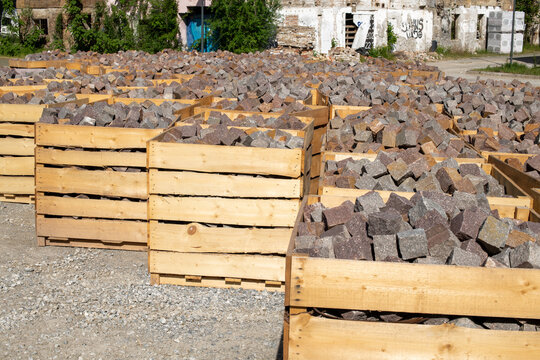 Large wooden crates containing stone paving blocks