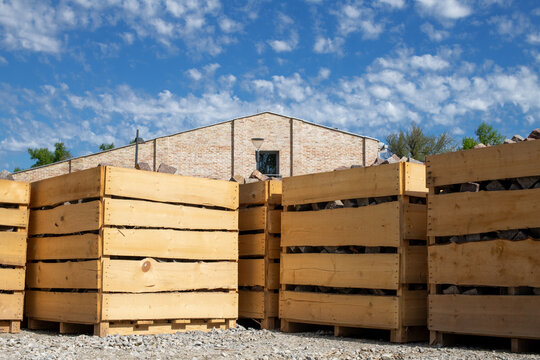 Large wooden crates containing stone paving blocks