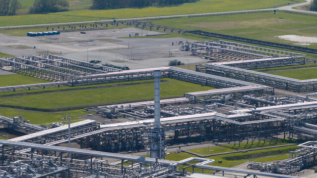 Aerial view of the NAM Grijpskerk UGS facility featuring an intricate network of industrial pipelines and a central exhaust stack Grijpskerk, Groningen, Netherlands.