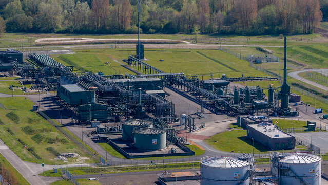 Aerial view of the NAM Grijpskerk UGS industrial facility with complex piping systems and storage tanks surrounded by green fields in Grijpskerk, Groningen, Netherlands.