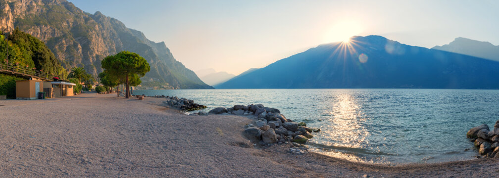 A deserted beach in Limone on Lake Garda. Sunrise over the mountains. tourist resort italy