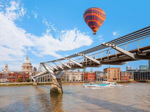 Hot air balloon flying over St Pauls Cathedral and Millennium Bridge - London, United Kingdom