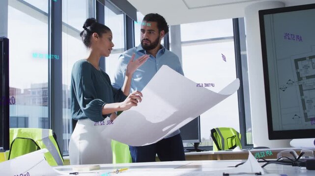 Woman holding blueprint and explaining design, man leaning in studying plans, finalizing decisions