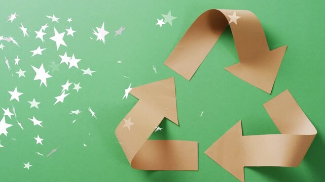 White stars starting from left edge sweeping over brown paper recycle symbol emphasizing eco theme