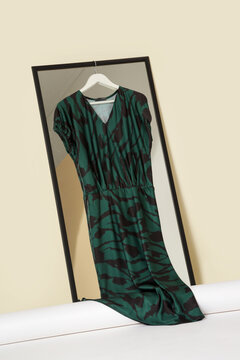 Luxury handmade clothes hanging on the hanger in fashion atelier. Fashion garment displayed on hanger in designer showroom.