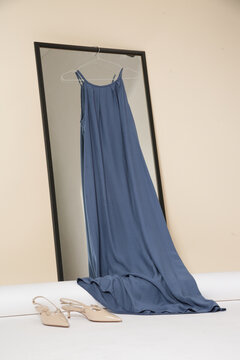 Luxury handmade clothes hanging on the hanger in fashion atelier. Fashion garment displayed on hanger in designer showroom.