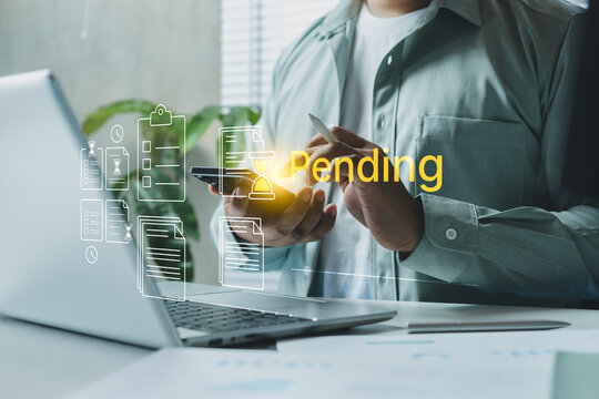Business professional reviewing digital document on smartphone and laptop, yellow pending status interface, online workflow delay, waiting approval process, corporate task management and compliance