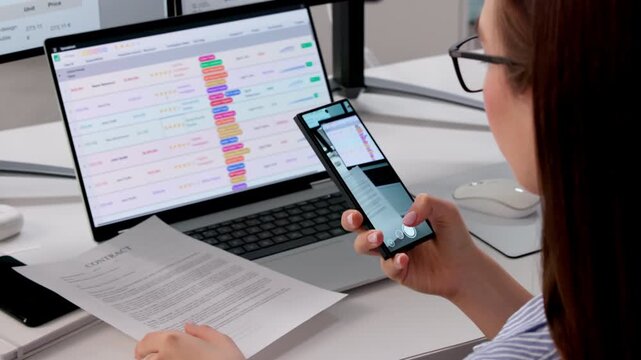 Office Manager Scanning Document With Smartphone