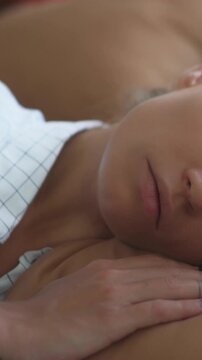 Sleeping woman with relaxed expression rests on her arm in a quiet intimate moment, showcasing serenity, soft lighting, and peaceful rest for wellness and lifestyle visuals