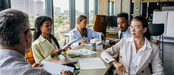 Workgroup collaboratively evaluates plans around conference table