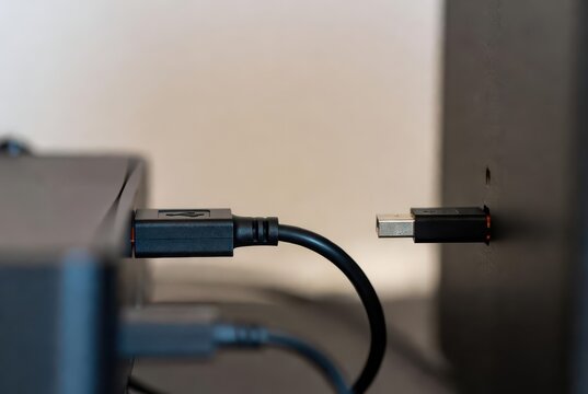 Close-up of USB-C cable connecting to a modern electronic device port, technology